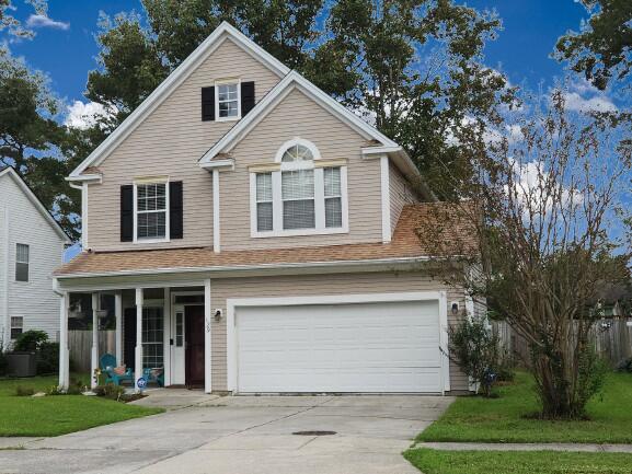 view of front property with a front lawn and a garage