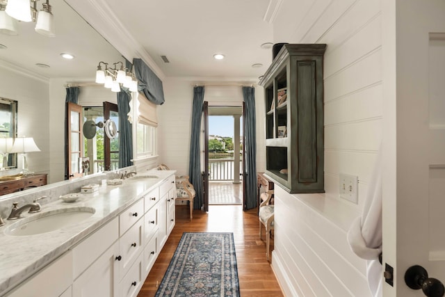 18 Fernandina St, Mount Pleasant, SC 29464 - full bath with wood finished floors, ornamental molding, double vanity, and recessed lighting