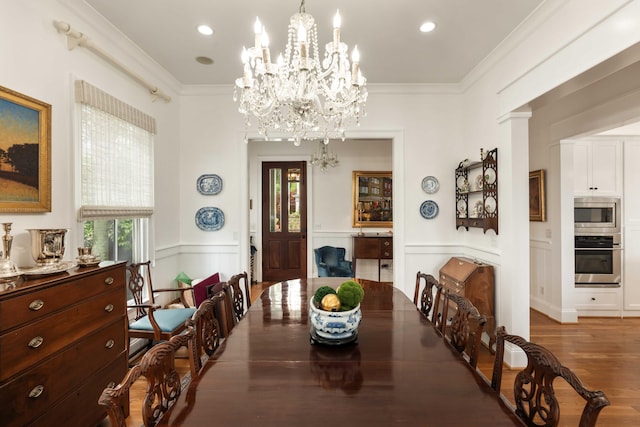 18 Fernandina St, Mount Pleasant, SC 29464 - dining space with healthy amount of natural light, a chandelier, a wainscoted wall, wood finished floors, and a decorative wall