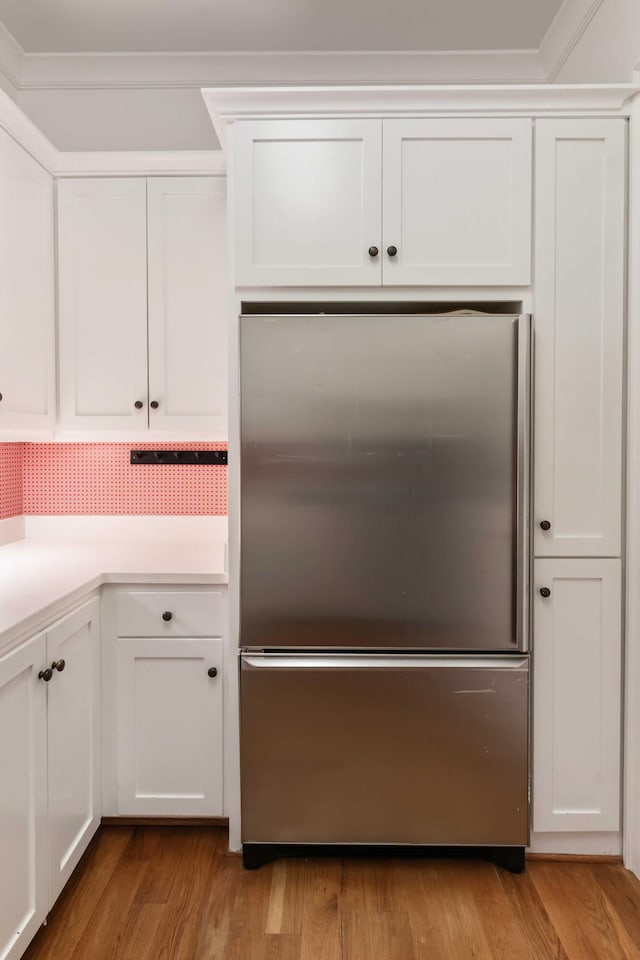 18 Fernandina St, Mount Pleasant, SC 29464 - kitchen with stainless steel fridge, white cabinets, light countertops, and light wood finished floors