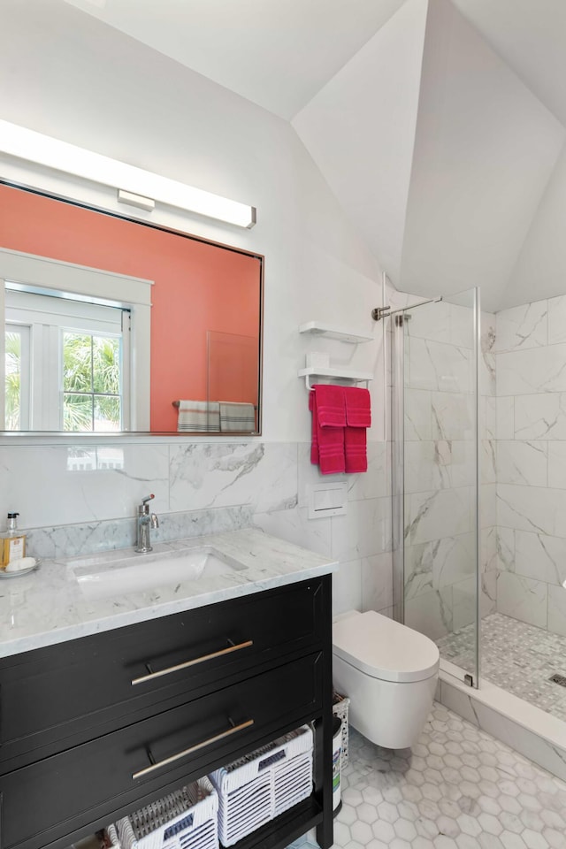 18 Fernandina St, Mount Pleasant, SC 29464 - bathroom featuring tile walls, vanity, a marble finish shower, toilet, and vaulted ceiling