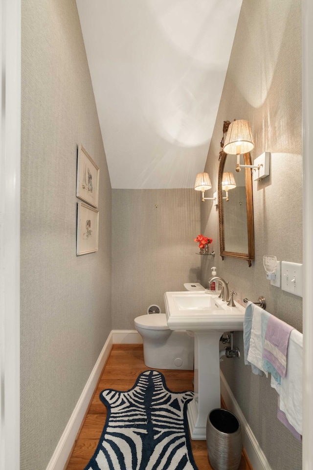 18 Fernandina St, Mount Pleasant, SC 29464 - bathroom with lofted ceiling, wood finished floors, toilet, and baseboards
