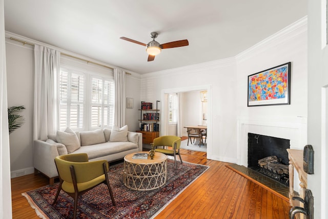 814 Rutledge Ave, Charleston, SC 29403 - living room with ceiling fan, crown molding, wood finished floors, baseboards, and a brick fireplace
