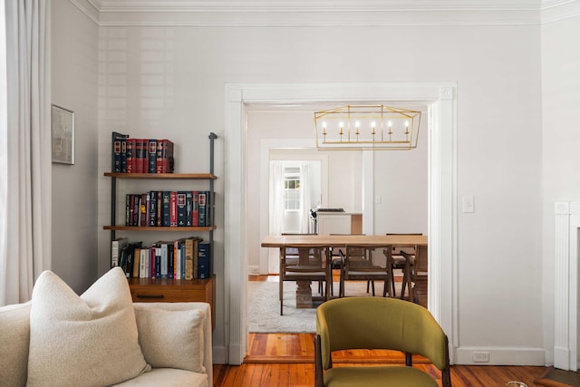 814 Rutledge Ave, Charleston, SC 29403 - sitting room featuring crown molding, a chandelier, wood finished floors, and baseboards