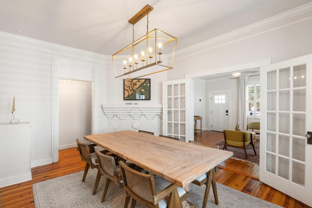 814 Rutledge Ave, Charleston, SC 29403 - dining area featuring crown molding, wood finished floors, a chandelier, baseboards, and french doors