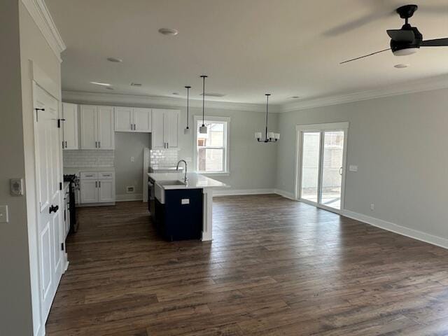4126 Ohear Ave, North Charleston, SC 29406 - kitchen with open floor plan, a ceiling fan, a chandelier, ornamental molding, and dark wood finished floors