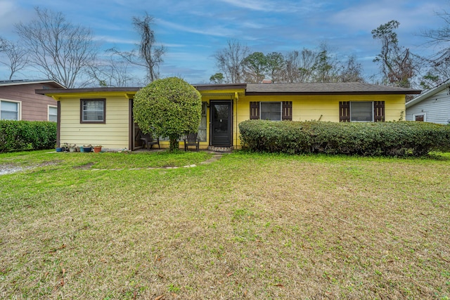 ranch-style home with a front lawn