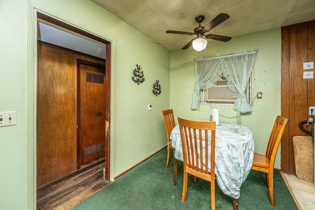 dining area featuring baseboards, a ceiling fan, and a textured ceiling