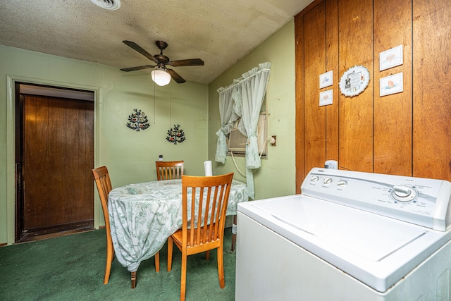 washroom featuring a textured ceiling, laundry area, a ceiling fan, dark colored carpet, and washer / clothes dryer