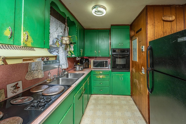 kitchen with light floors, light countertops, a sink, green cabinetry, and black appliances