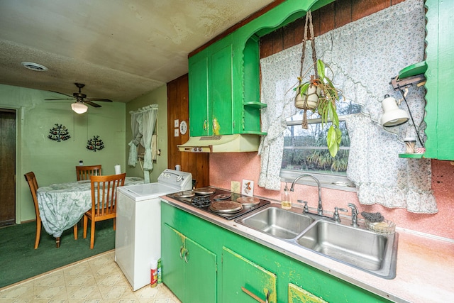 kitchen featuring washer / dryer, visible vents, light countertops, under cabinet range hood, and a sink