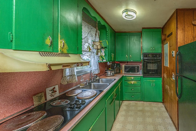 kitchen with light floors, green cabinetry, a sink, and black appliances