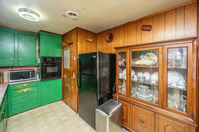 kitchen featuring black appliances, light floors, glass insert cabinets, and visible vents