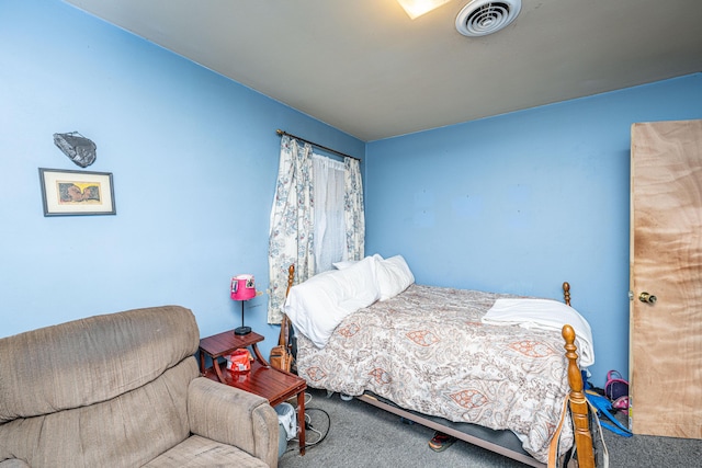 carpeted bedroom featuring visible vents