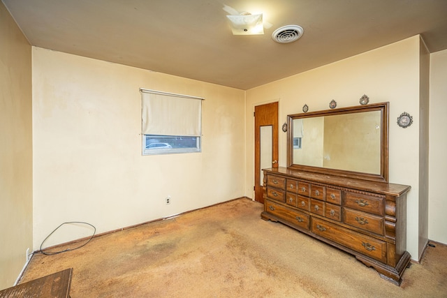 bedroom with light colored carpet and visible vents