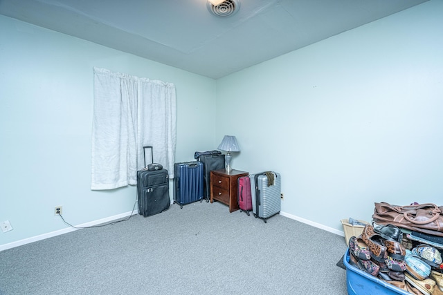 miscellaneous room featuring carpet floors, visible vents, and baseboards