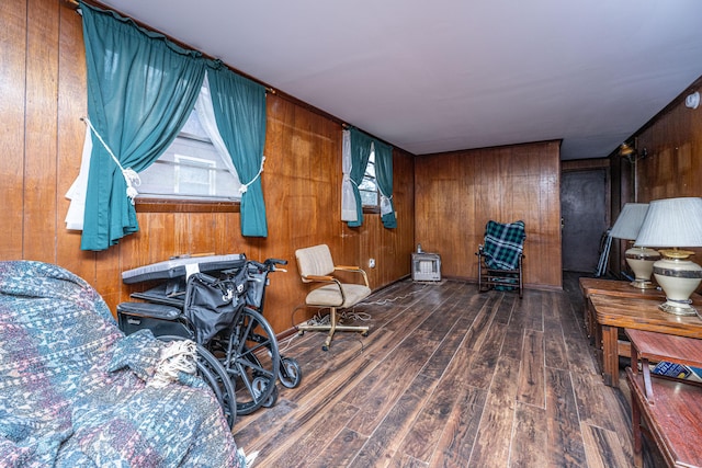 sitting room featuring dark wood finished floors and wooden walls