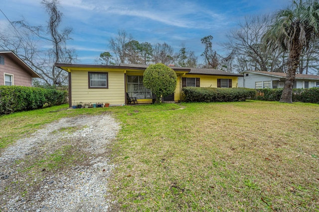 single story home with driveway and a front yard