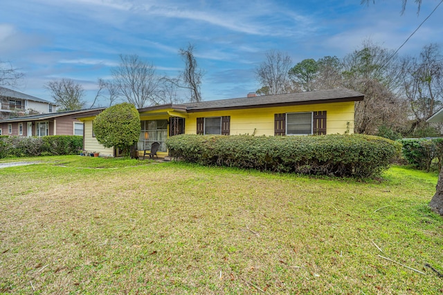 ranch-style home with a front lawn