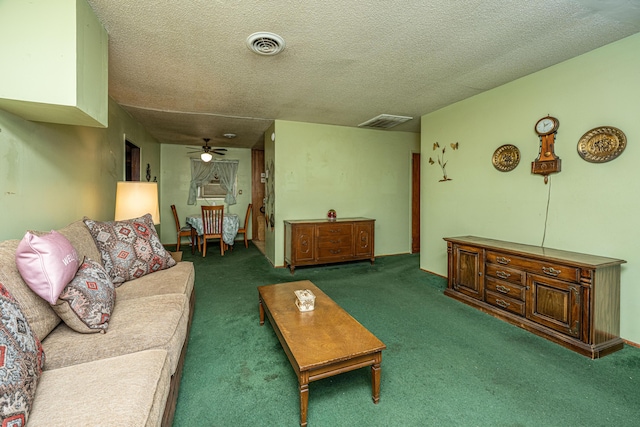 living area featuring ceiling fan, visible vents, and a textured ceiling