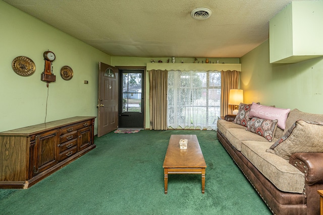 living area with visible vents, a textured ceiling, and carpet flooring