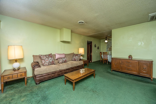 carpeted living room with a textured ceiling, visible vents, and a ceiling fan