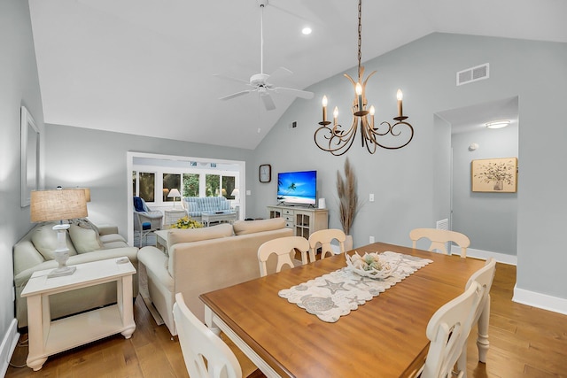 dining space with light wood-type flooring, visible vents, baseboards, and ceiling fan with notable chandelier