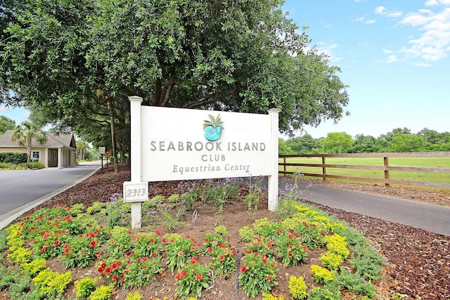 community sign featuring fence