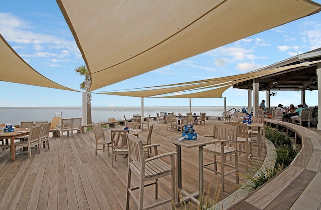 exterior space featuring a water view and outdoor dining space