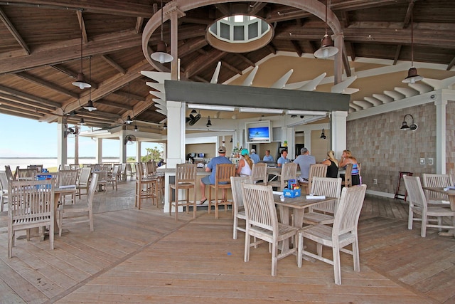 unfurnished dining area with wood ceiling, beamed ceiling, high vaulted ceiling, and hardwood / wood-style floors