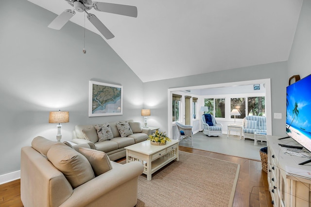 living area with a ceiling fan, wood finished floors, baseboards, and high vaulted ceiling