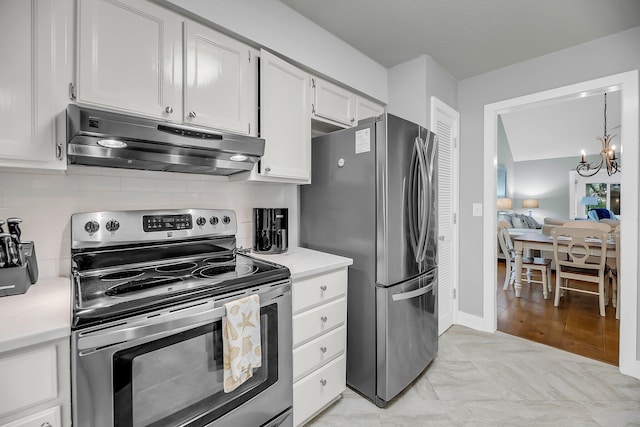 kitchen featuring under cabinet range hood, stainless steel appliances, an inviting chandelier, white cabinets, and light countertops