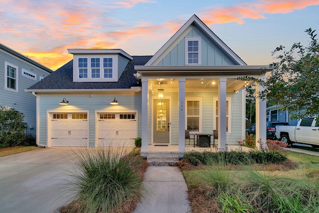 view of front of property with covered porch and a garage