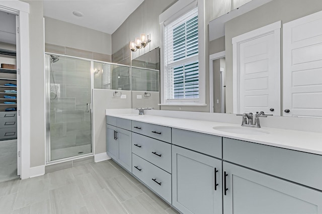 bathroom featuring an enclosed shower and vanity