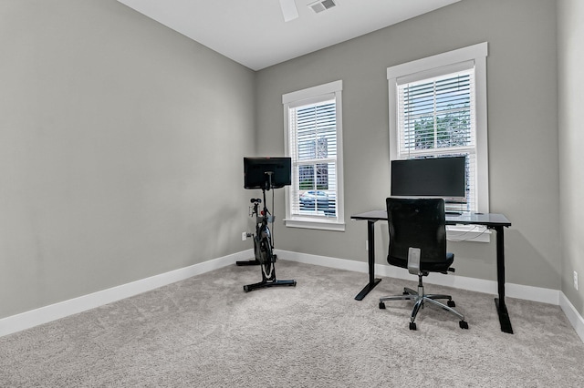 carpeted home office with lofted ceiling