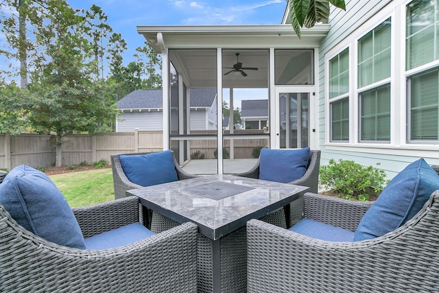 view of patio / terrace featuring ceiling fan and a sunroom