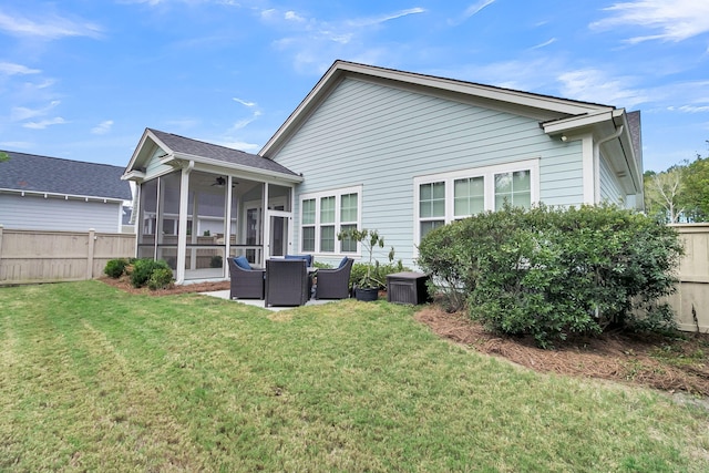 back of property featuring a lawn and a sunroom