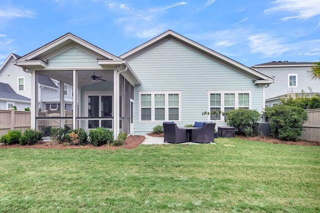 rear view of property with a lawn, ceiling fan, and a sunroom