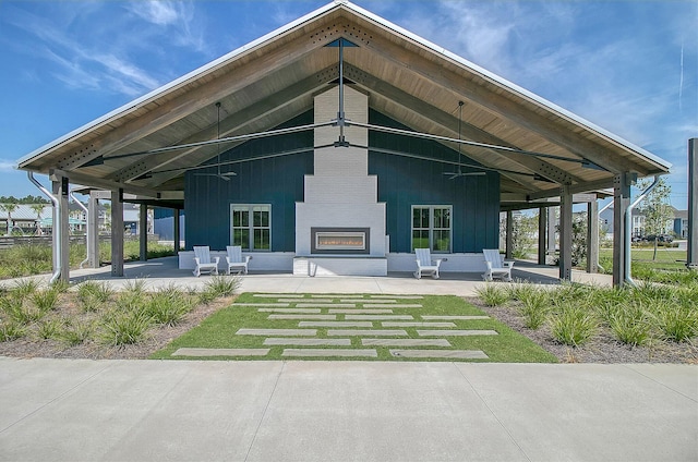 rear view of property with a patio area and a fireplace