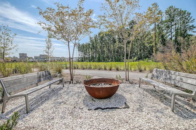 surrounding community featuring an outdoor fire pit