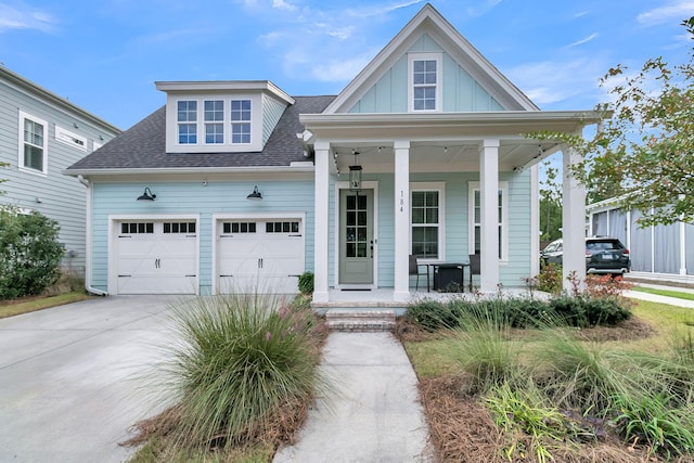 view of front of house featuring a porch and a garage