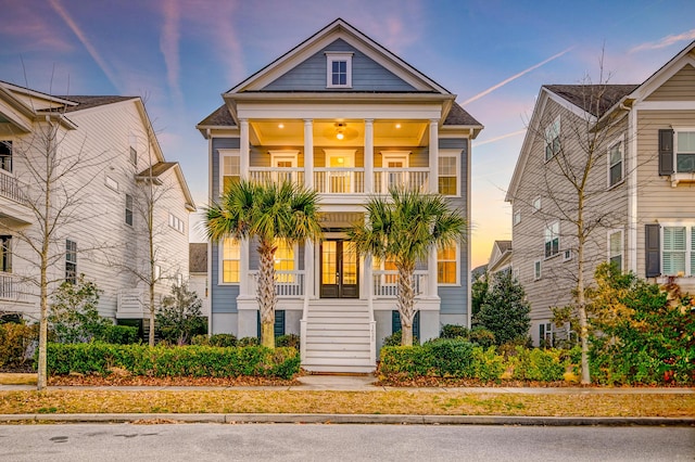 view of front of home featuring a balcony and french doors