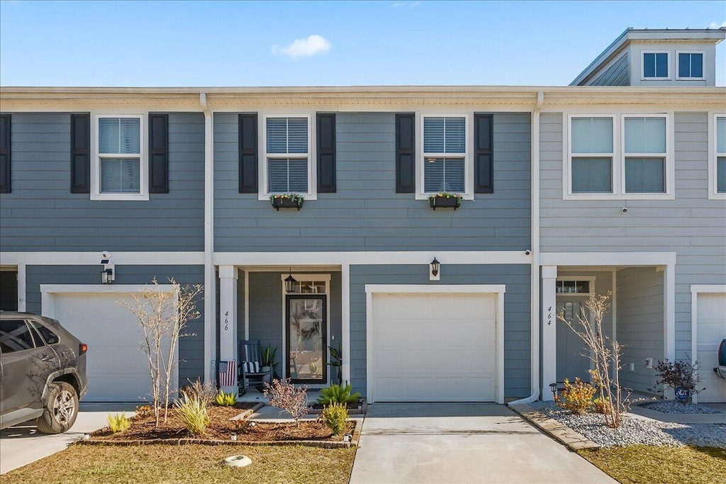 townhome / multi-family property featuring a garage