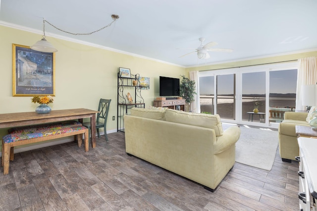 living room with ceiling fan, wood finished floors, baseboards, and ornamental molding