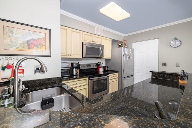 kitchen featuring a sink, cream cabinets, ornamental molding, and stainless steel appliances