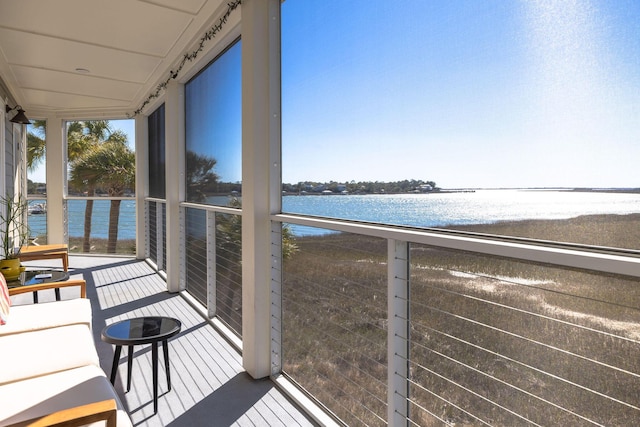 balcony with a water view and a sunroom