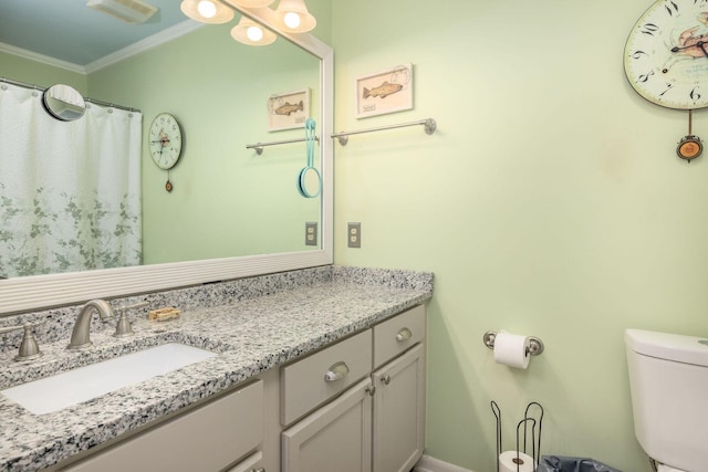 bathroom featuring visible vents, toilet, vanity, and ornamental molding