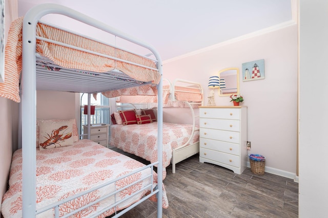 bedroom featuring crown molding, wood finished floors, and baseboards