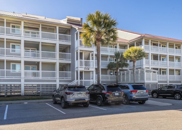 view of building exterior with uncovered parking