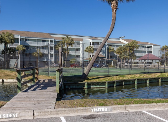 dock area featuring a water view and fence